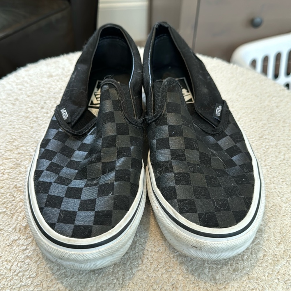 Vans black checkerboard slip-ons